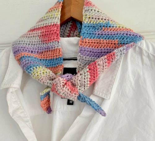 Crochet Neckerchief Colourful crocheted neck scarf tied around a white collared shirt.